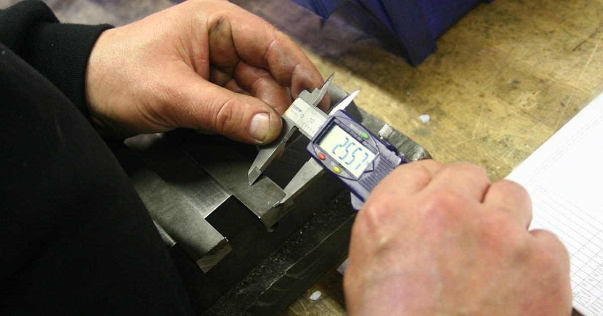 A professional worker inspecting house finishing details like tiles and painting